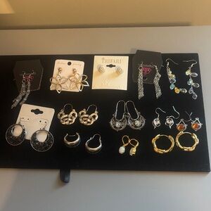 13 pair of silver/goldtone earrings. Like new.
